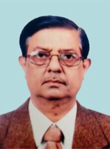 An indian man wearing glasses and a suit.